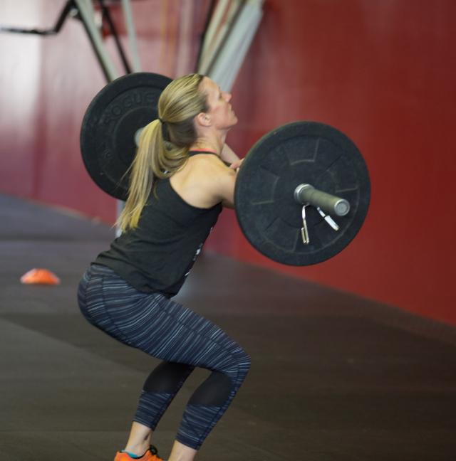 female athlete lifting barbell